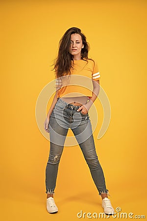 Sexy girl yellow background. Sexi girl. Sensual girl in casual style. Beauty and make up. Pretty girl with long hair Stock Photo