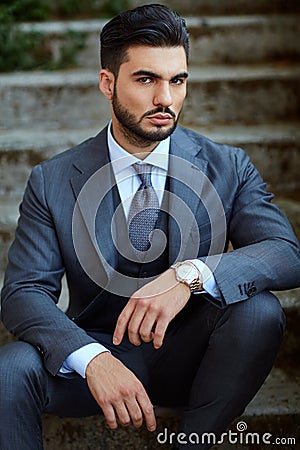 Fashion businessman sit down on old stairway Stock Photo