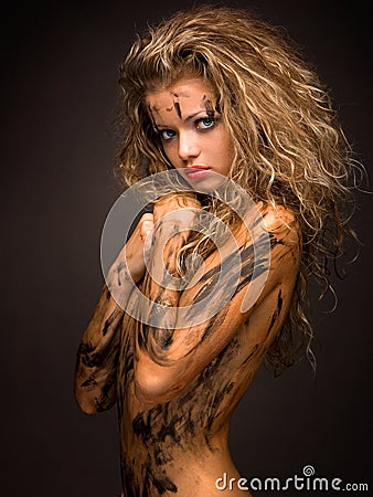 and innocent woman with paint smudge on her naked body Stock Photo