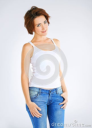 Sexy kept simple. Studio portrait of a young woman posing against a grey background. Stock Photo