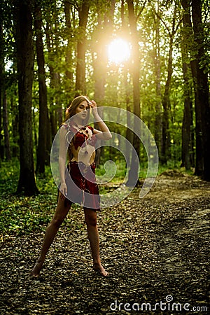 Sexy legs. amazon woman. sexy witch. cougar female. wild woman in forest. sexy girl in leather suede clothes. ethnic Stock Photo
