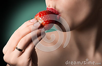 lips with strawberry. Natural skin. Green background. Hot k Stock Photo