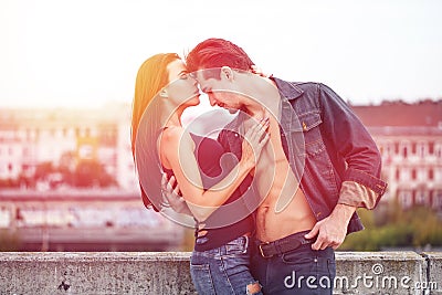 macho man holding brunette lover in sunset Stock Photo