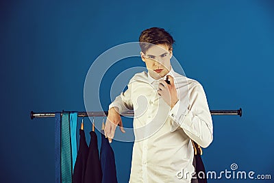 man with bottle of perfume in shirt with hanger Stock Photo