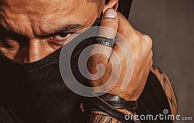 Sexy man cover face. Close up portrait of guy with serious profile face. Guy covered face with hands and doing stop Stock Photo