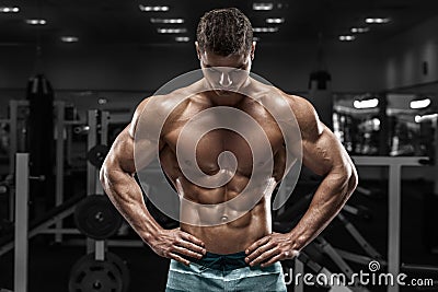 muscular man in gym, shaped abdominal. Strong male naked torso abs, working out Stock Photo