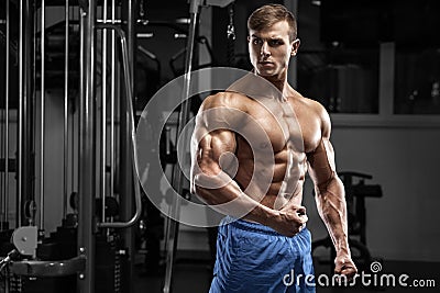 muscular man in gym. Strong male torso abs, workout Stock Photo