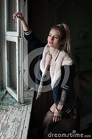 Sexy pinup girl in underwear posing in abandoned building. Stock Photo