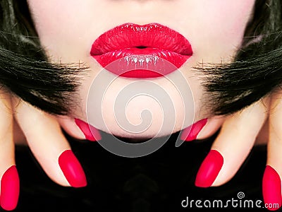 pretty woman with black hair, red lips and fingernails sending a kiss / smooch Stock Photo