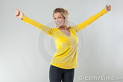 20s blond woman smiling with arms opened for joy Stock Photo