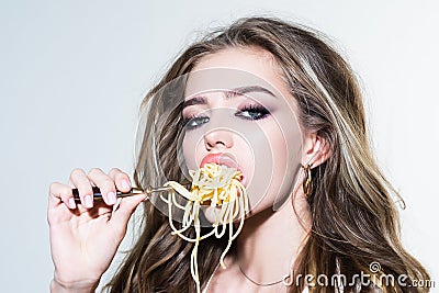 Sexy seductive cheeky girl eats a pasta. Stock Photo