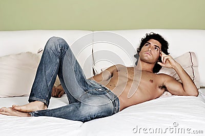 shirtless young man on bed Stock Photo