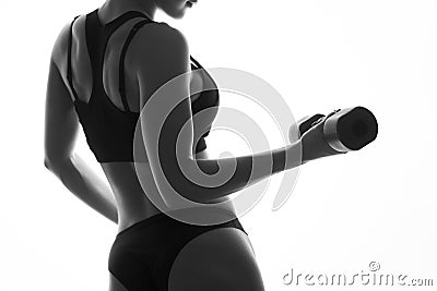 slim fit woman body with dumbbells. Muscled back. Sportswea Stock Photo