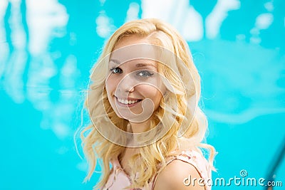 Sexy slim gorgeous young blonde is relaxing by the pool in a luxury hotel Stock Photo