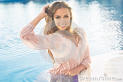 smiling woman is wearing silk shirt in Stock Photo