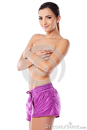 topless woman in pink shorts Stock Photo