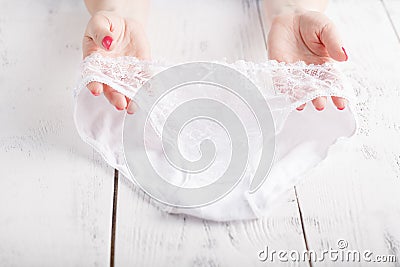 transparent panties on white background in female hands Stock Photo