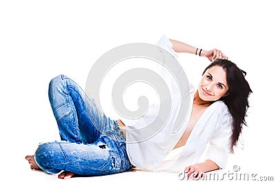 woman in blue jeans lying on white floor Stock Photo