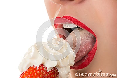 woman eating strawberry with cream, sensual red lips Stock Photo