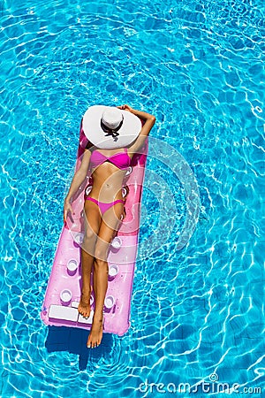 woman on a float in the pool Stock Photo