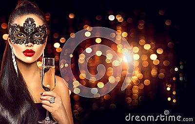 woman with glass of champagne wearing venetian masquerade mask Stock Photo