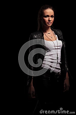 woman in leather jacket and undershirt standing Stock Photo