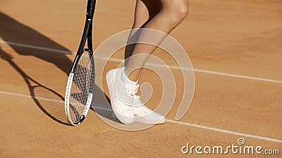 woman legs, pretty athlete woman in sportswear posing on tennis court Stock Photo