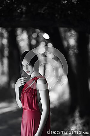 woman in red dress in fairy forest. Beauty springtime Stock Photo