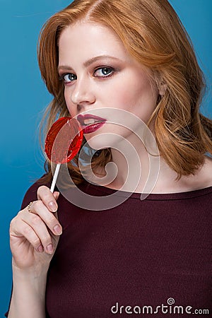 woman with red lips holding lollipop, Stock Photo