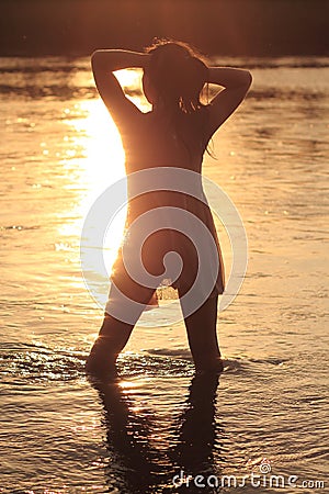 Woman in River in Sunset Stock Photo