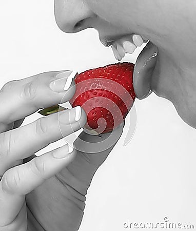 woman tasting a strawberry Stock Photo