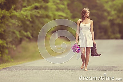 woman walking with boots Stock Photo