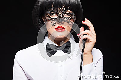 woman in wig posing with whip Stock Photo