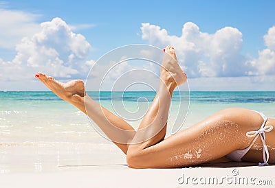 women legs on the beach Stock Photo