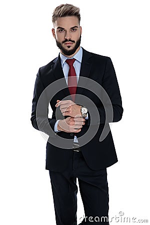 Sexy young businessman arranging watch Stock Photo