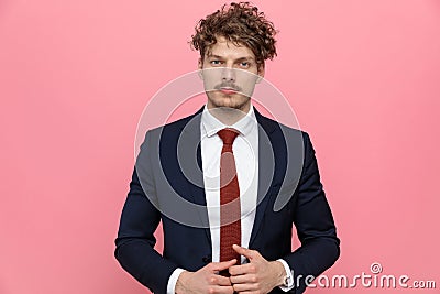 Sexy young businessman in navy blue suit touching fingers Stock Photo