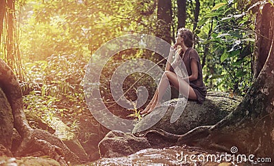 young lady resting in the tropical forest Stock Photo