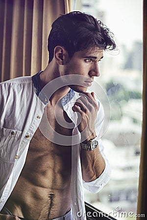 young man with shirt open on muscular chest Stock Photo