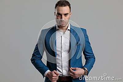 Sexy young smartcasual man adjusting blue coat Stock Photo