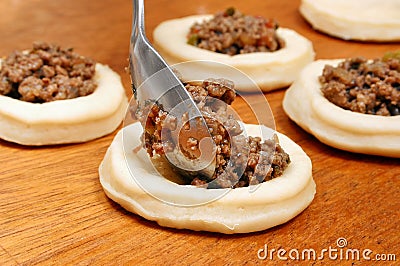 sfihas of meat being stuffed Stock Photo