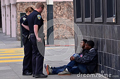 SFPD officers interrogating black american men in San Francisco Editorial Stock Photo