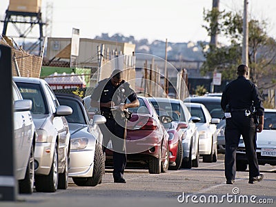 SFPD Police officers write parking tickets along street Editorial Stock Photo