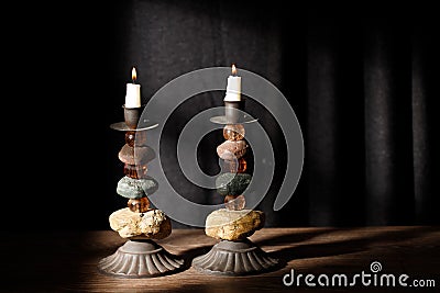 Shabbat candlesticks with burning candles on the kitchen table. Traditional Jewish Shabbat ritual. Shabbat Shalom Stock Photo