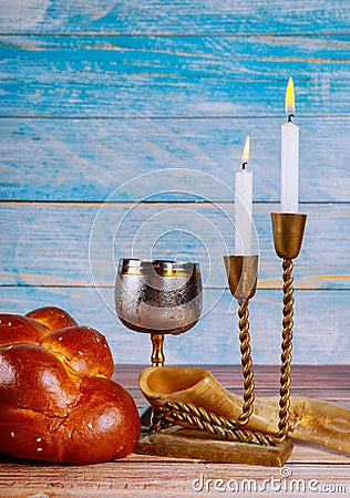 Shabbat eve table candles and cup of wine with covered challah bread Stock Photo
