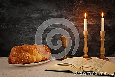 shabbat image. challah bread, shabbat wine and candles on the table. Stock Photo