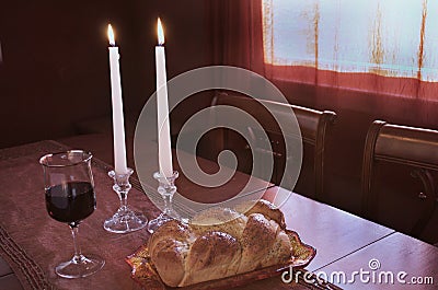 Shabbat Observance At Sunset: Challah, Glass of Wine, Two Lit Candles Stock Photo