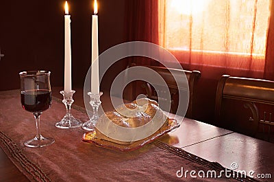 Shabbat Observance At Sunset: Challah, Glass of Wine, Two Lit Candles Stock Photo