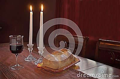 Shabbat Observance At Sunset: Challah, Glass of Wine, Two Lit Candles Stock Photo