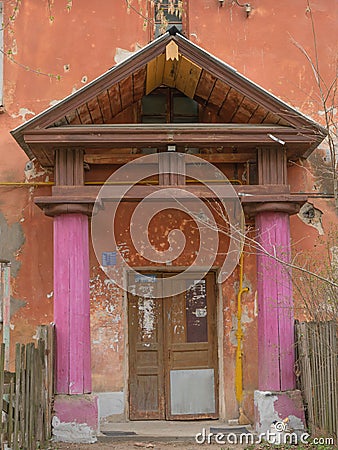 A shabby entrance with pink columns Stock Photo