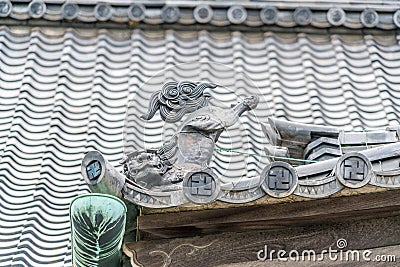 shachi or shachihoko (killer whale) Fish shaped ornament at Tomebuta gawara of Sengaku-ji Soto Zen Buddhist temple. Tokyo, Japan. Editorial Stock Photo